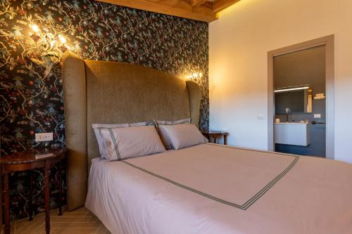 a bedroom with a bed with a headboard at Masseria D'Achille in Castel di Sangro