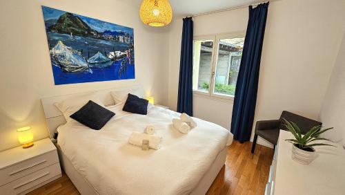 a bedroom with a bed with two stuffed animals on it at Bellavista Apartment with Free Parking in Lugano