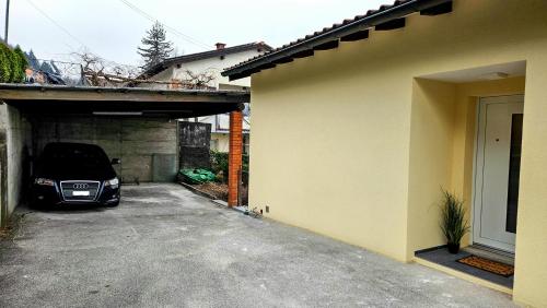 a car parked in a garage next to a house at Bellavista Apartment with Free Parking in Lugano