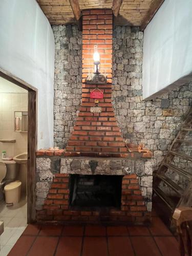 a brick fireplace with a light on top of it at Mi casita de Los Andes in San Rafael