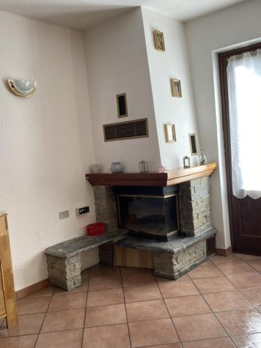 a living room with a stone fireplace in a room at APPARTAMENTO MORGEX in Morgex