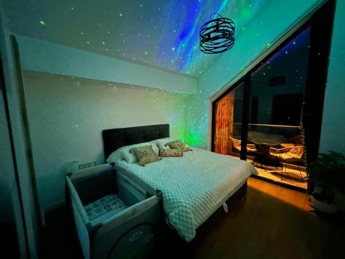 a bedroom with a bed with a star ceiling at Divcibare Vrh 26 in Divčibare