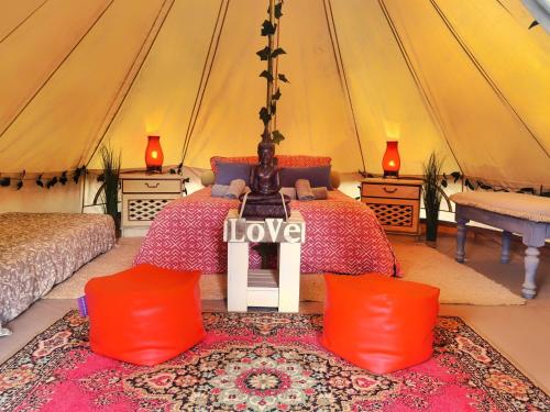a bedroom with a bed in a tent at Bell Tent Lovers by Casa das Artes in Luz de Tavira