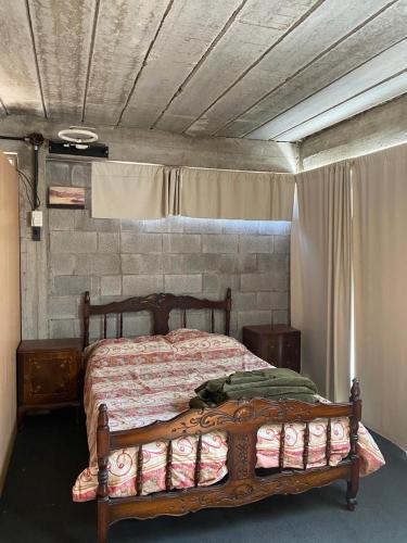 a bedroom with a bed with a wooden frame at departamento A City Bell in City Bell