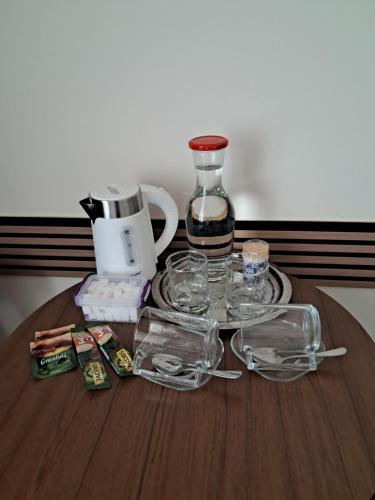 a table with glasses and a coffee maker on it at city point in Kutaisi