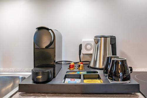 a counter top with a coffee maker and a blender at Well-Home Apartments Velden in Velden am Wörthersee