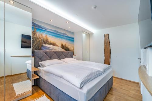 a bedroom with a bed with a painting on the wall at Well-Home Apartments Velden Top1 in Velden am Wörthersee