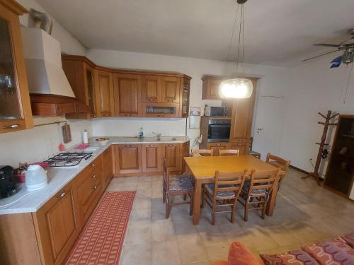 a kitchen with wooden cabinets and a wooden table at Carpe Diem in Treviso