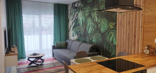 a living room with a couch and a table at Apartament Zacisze 13 in Piaseczno