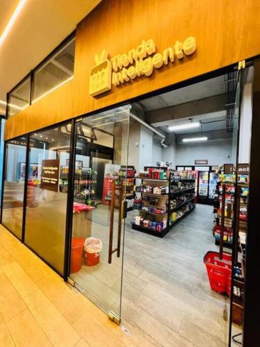 a store front of a grocery store with a sign on it at Apartamento 2 Habitaciones, Edificio Airali, Zona 10, Napoles in Guatemala