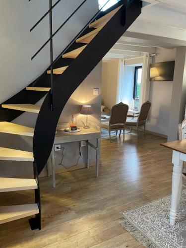 a staircase in a room with a table and chairs at les gites du grand saule in Tardinghen