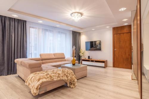 a living room with a couch and a table at City Lights Apartments in Krakow