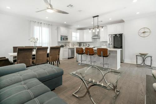 a living room with a blue couch and a kitchen at New 3-Bed Luxury House in New Orleans