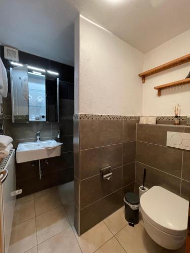 a bathroom with a toilet and a sink at Adam & Eva Gasthof Paradies mit Hotel in Vogt