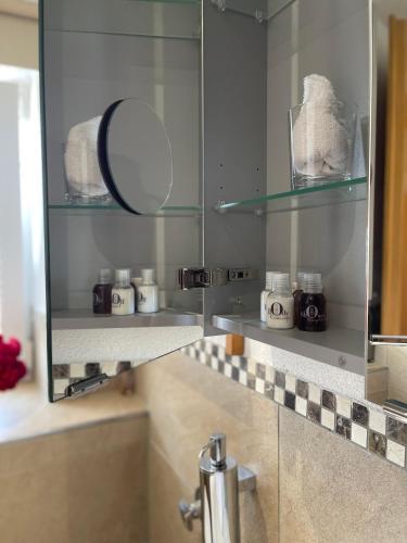 a bathroom with a mirror and a sink at Adam & Eva Gasthof Paradies mit Hotel in Vogt