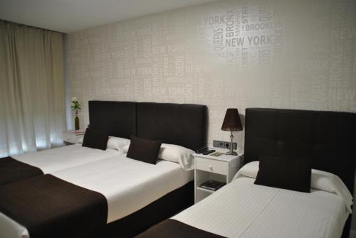 a hotel room with two beds at Hotel Junquera in Vigo