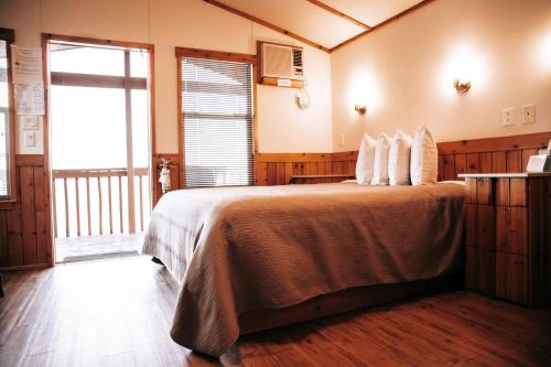 a bedroom with a large bed with pillows on it at Mountain View Lodge in Fort Davis