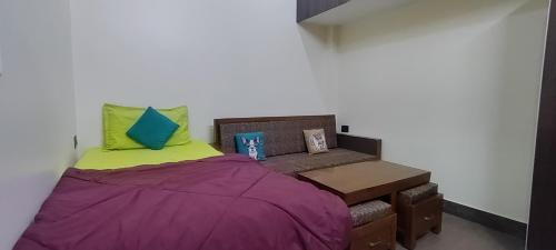 a small bedroom with a bed and a chair at Sumptuous 1BHk Couple friendly in Lucknow