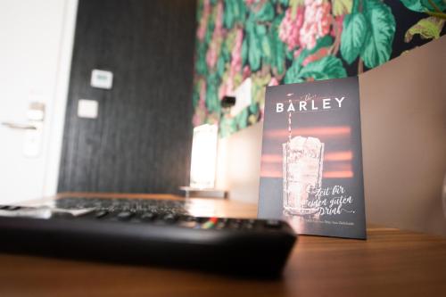 a book sitting on a desk next to a keyboard at Stay-Inn Bielefeld Zentrum in Bielefeld