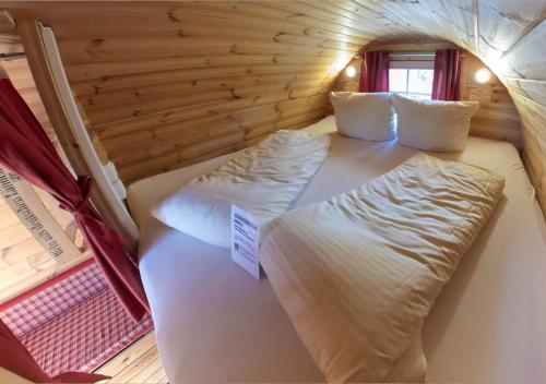 a room with two beds in a log cabin at Rheingau 524 Schlaffassdorf direkt am Rhein in Geisenheim