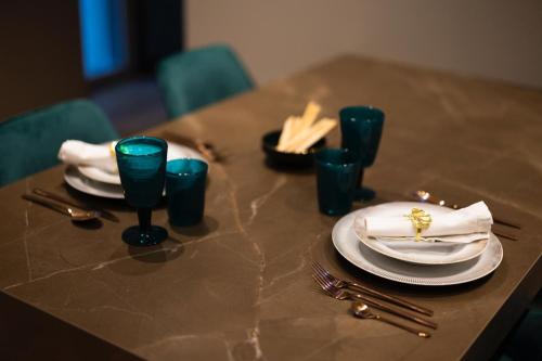a table with plates and utensils on it at Pescara INN Via Sulmona 17 in Pescara
