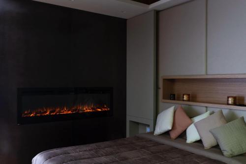 a bedroom with a fireplace and a bed with pillows at Pescara INN Via Sulmona 17 in Pescara