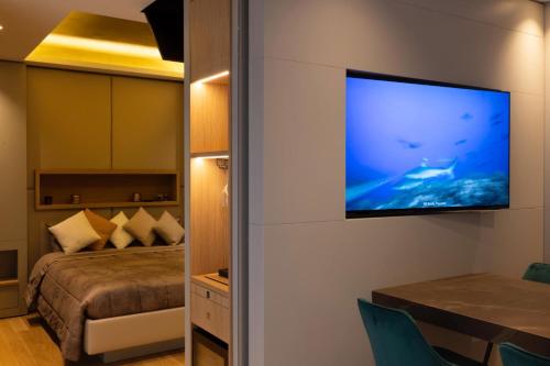 a bedroom with a bed and a flat screen tv on a wall at Pescara INN Via Sulmona 17 in Pescara