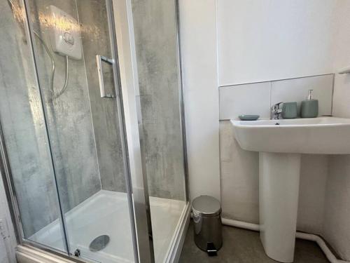 ein Bad mit einer Dusche und einem Waschbecken in der Unterkunft Radiant Accommodation Manor Lane in Plymouth