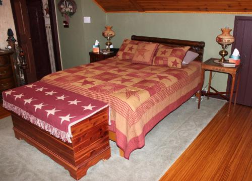 a bedroom with a large bed with an american flag bedspread at Carriage Stop Bed & Breakfast in Palmyra