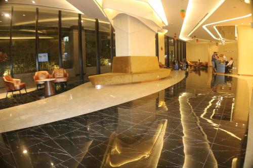 a lobby of a building with a table in the middle at Axon Service Suites At Bukit Bintang KL in Kuala Lumpur