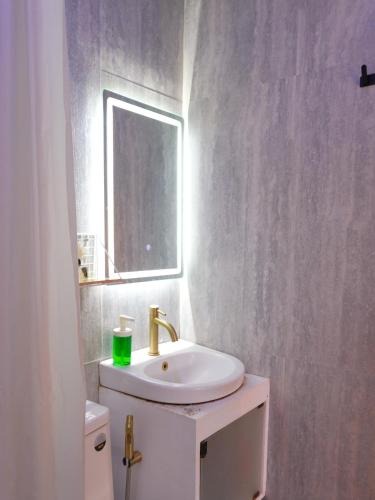 a white bathroom with a sink and a mirror at Urban Oasis Resort, Tarlac in Tarlac
