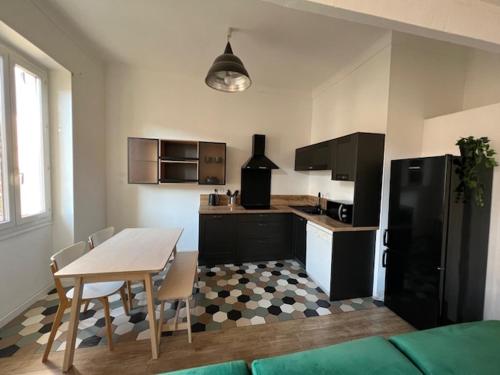 Il comprend une cuisine équipée d'une table et d'un réfrigérateur. dans l'établissement Appartement cosy centre ville NICE, à Nice