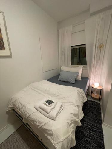 a bedroom with a bed with a towel on it at Arctic Homestay with Northern light view room in Tromsø