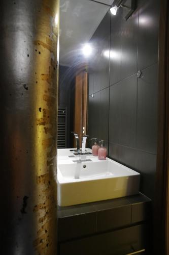 La salle de bains est pourvue d'un lavabo blanc et d'un miroir. dans l'établissement Aθens Dome - Apartments by Live&Travel, à Athènes
