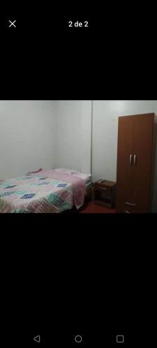 a picture of a bedroom with a bed and a cabinet at Hospedaje BERTHITA in Chiclayo