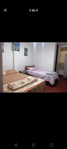 En eller flere senge i et værelse på Hospedaje BERTHITA