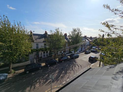 a city street with cars parked on the street at Cosy and quiet one bedroom Thames flat in London