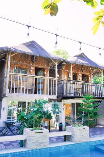 a house with a pool in front of it at Urban Oasis Resort, Tarlac in Tarlac