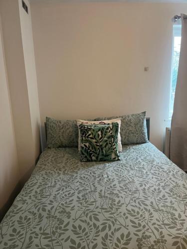 a bed with pillows in a small bedroom at Juana's private room in Manchester