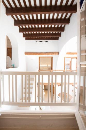 a room with a balcony with a wooden ceiling at Casa Concha Apartamentos in Calella de Palafrugell