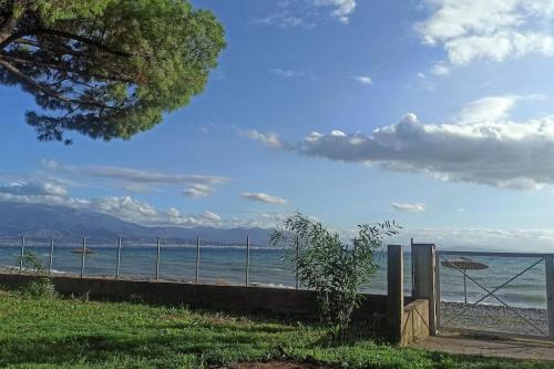 a gate to the beach with the ocean in the background at Rizaki Cottage in Nafpaktos in Nafpaktos