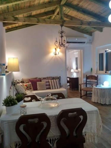 a living room with a table and a couch at Rizaki Cottage in Nafpaktos in Nafpaktos