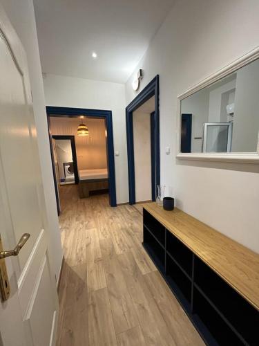 a living room with a wooden floor and a mirror at Collie’s place in Koper