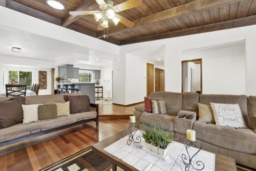 a living room with two couches and a ceiling fan at 2382-Belmont Pines Cottage cabin in Big Bear City