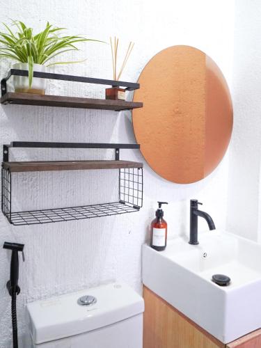 a bathroom with a sink and a mirror at Urban Oasis Resort, Tarlac in Tarlac