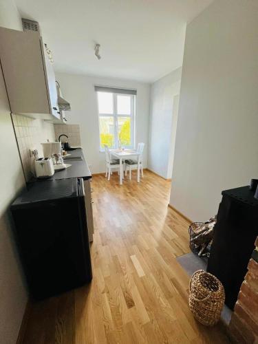 a kitchen with a counter and a table in a room at Ilmarise Apartment in Viljandi