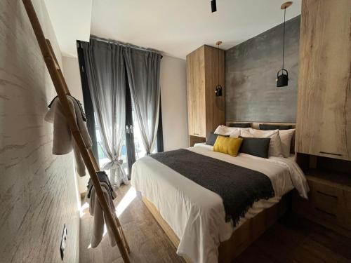 a bedroom with a large bed and a large window at G&A casa centrale in Ioannina