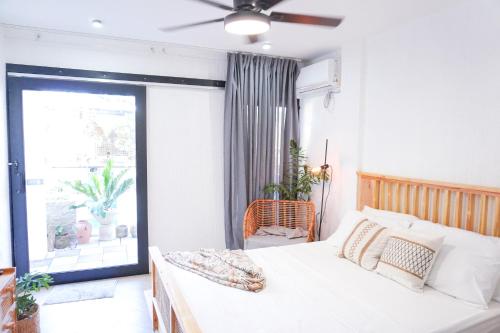 a bedroom with a bed and a large window at Urban Oasis Resort, Tarlac in Tarlac