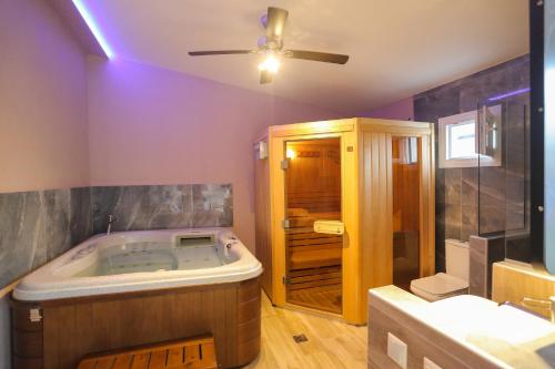 a large bathroom with a tub and a shower at Pegasus' Glory House in Kavála