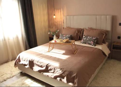 a bedroom with a large bed with a table on it at Theasis home 